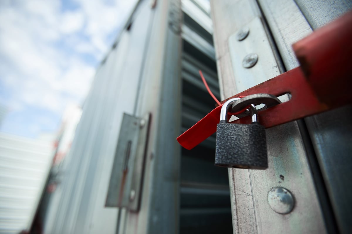 Close-up of a closed cargo container with a lock, sealed container in warehouse area
