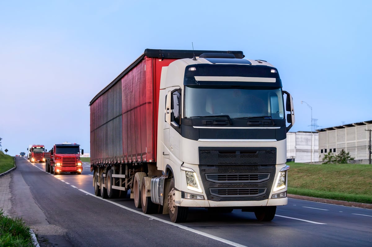 Modern cargo trucks on highway representing logistics and freight transportation