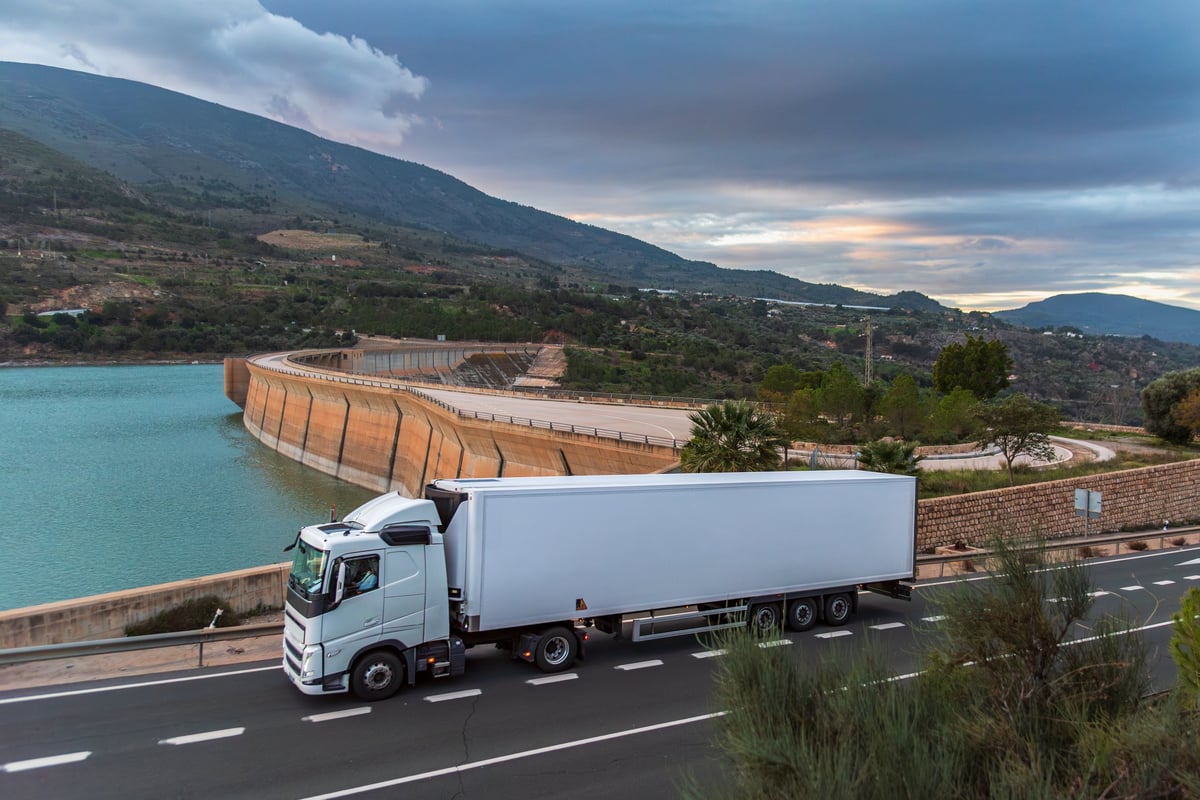 Refrigerated truck driving on a country road, cold chain transport