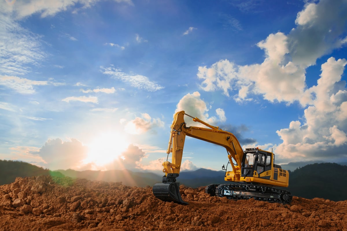 Crawler excavators digging on a construction site representing construction and machinery companies