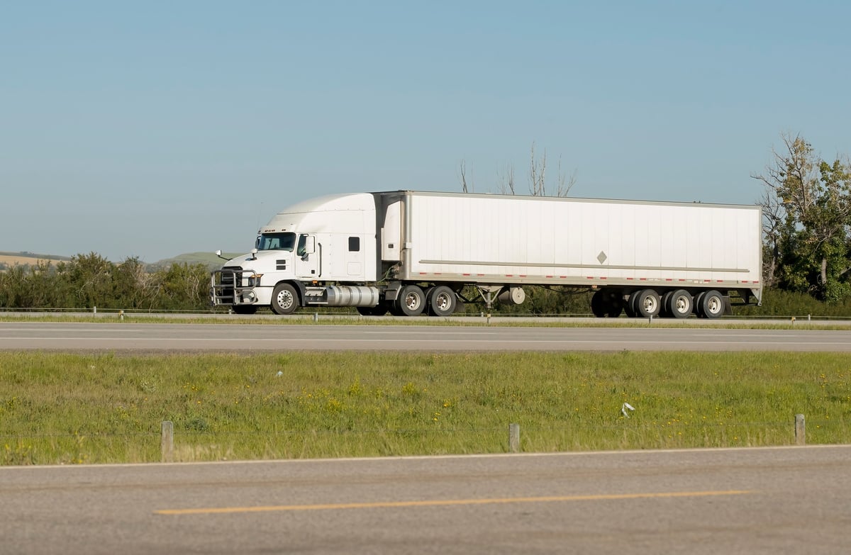 A truck hauling freight along the Queen Elizabeth II Highway near Airdrie