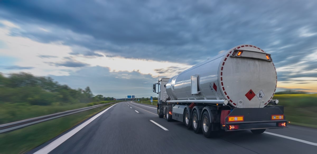 A tanker truck traveling on a highway representing fuel control and liquid freight transport